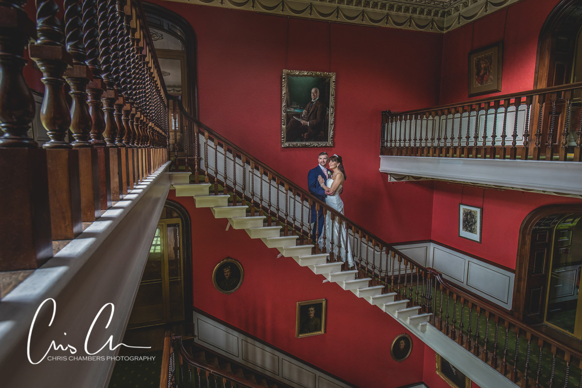 Bride and groom wedding photo on the main staircase. North yorkshire. Swinton Park Wedding Photograph