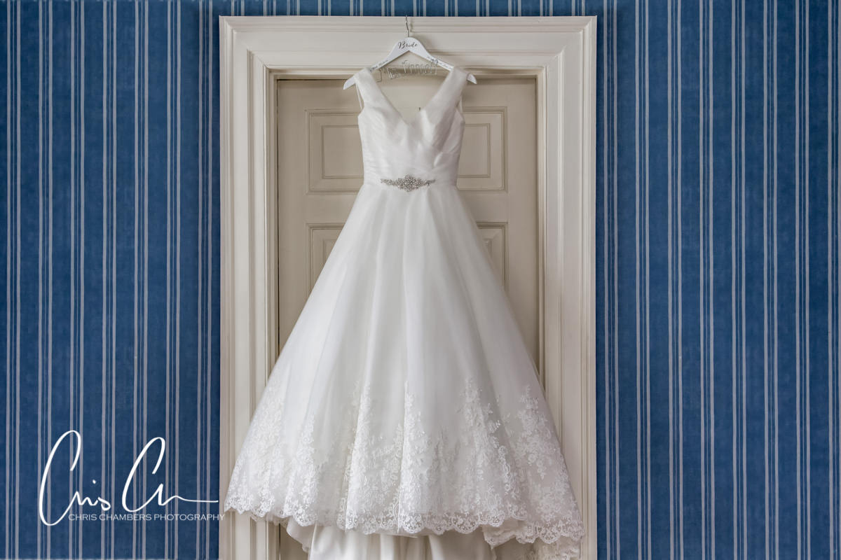 The brides dress hanging up. Swinton Park Wedding Photograph