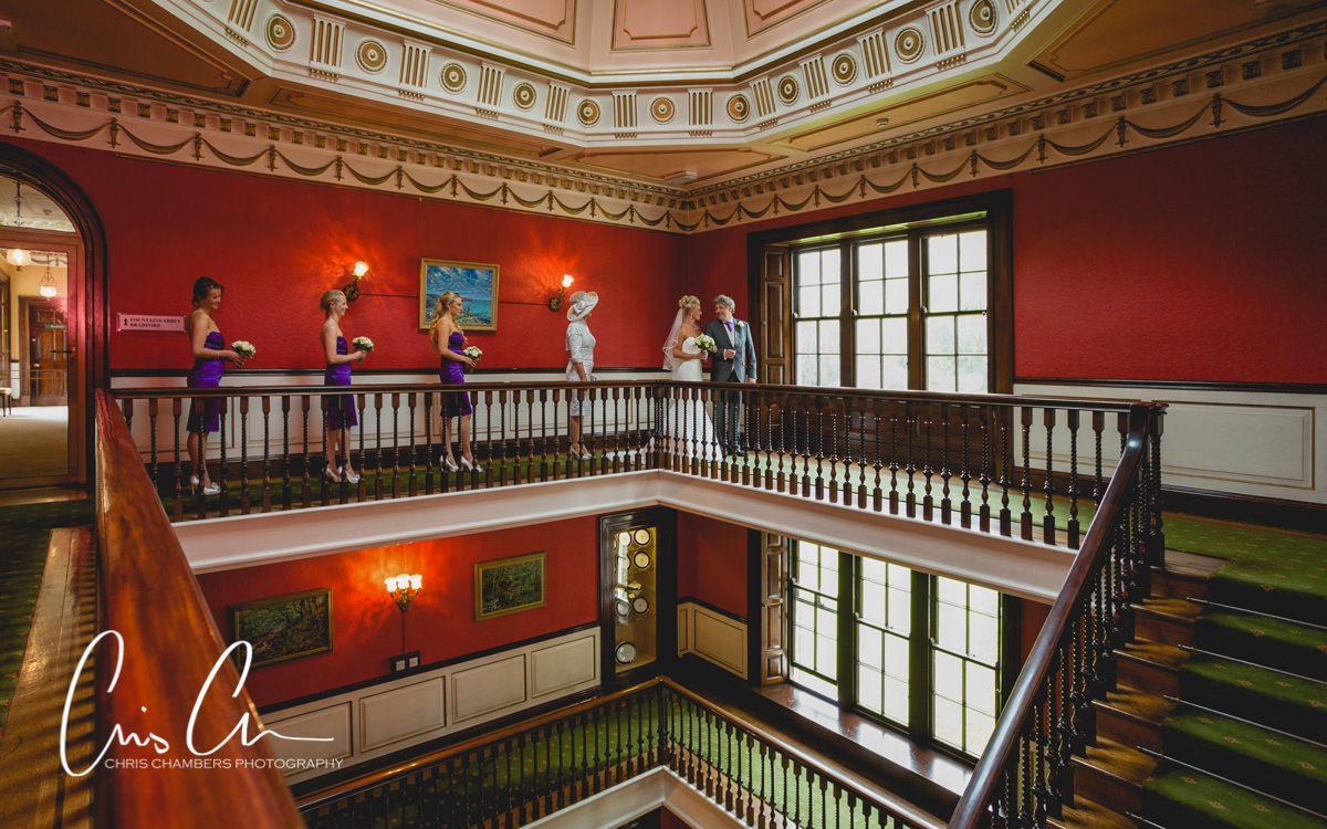 Bride and bridesmaids on the staircase at Swinton Park, North Yorkshire wedding venue. Swinton Park Wedding Photograph