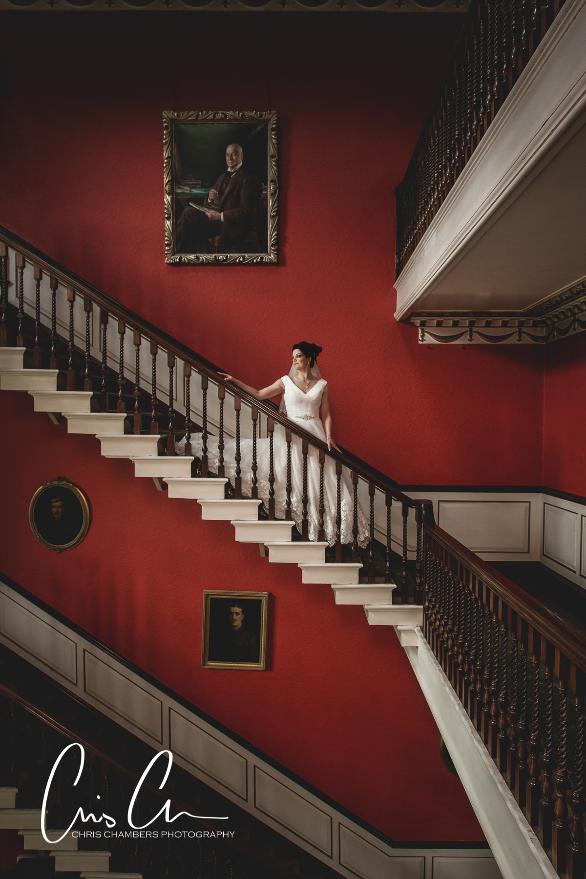 Bride alone. wedding photo on the main staircase. North yorkshire. Swinton Park Wedding Photograph