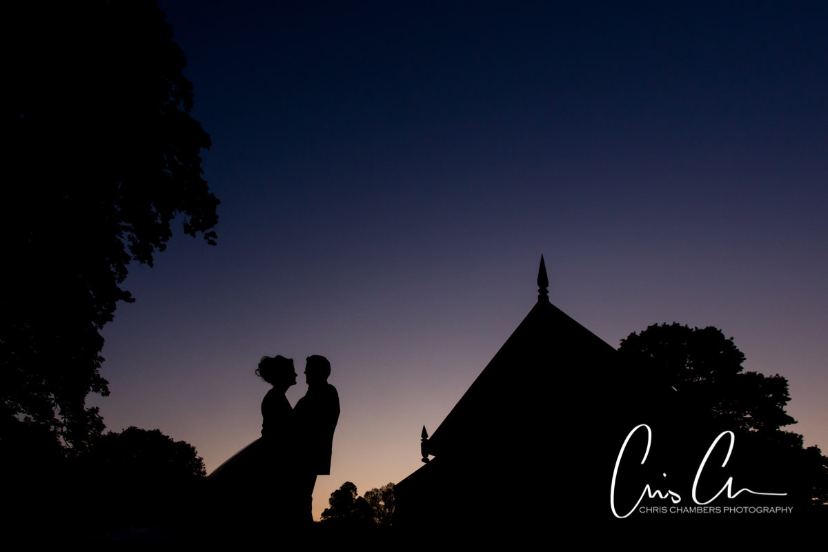 Sunset silhouette wedding photograph of a bride and groom at Swinton Park