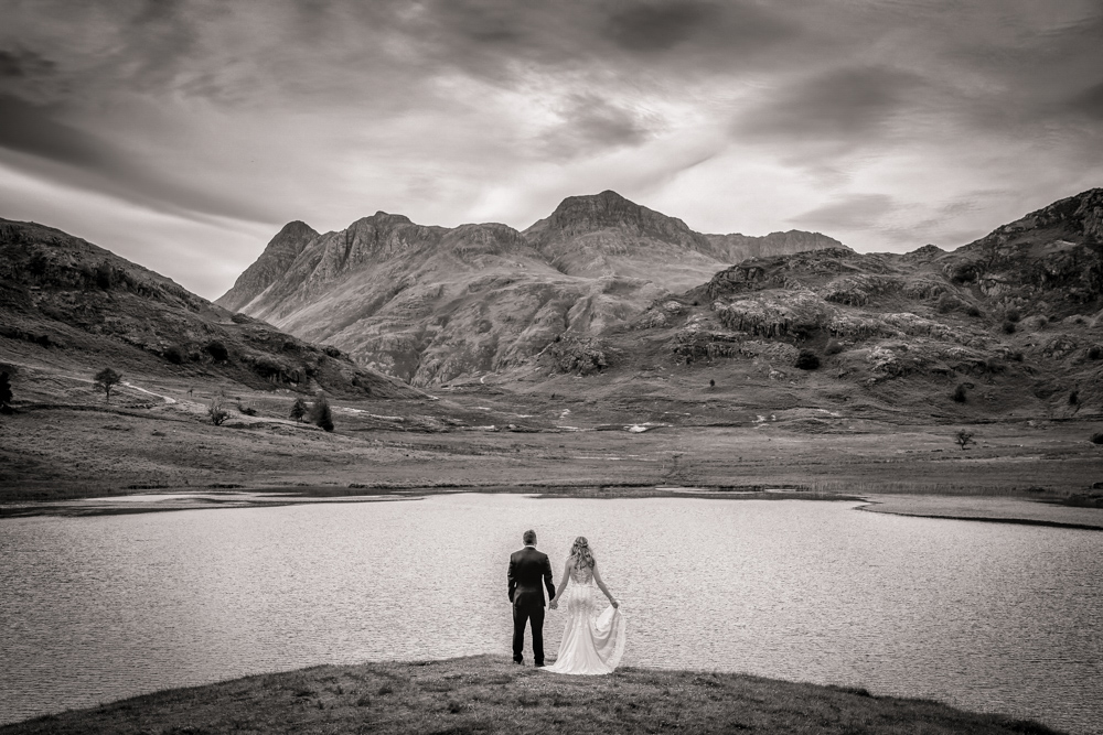 Lake District wedding photograph of bride and groom overlooking mountains. Yorkshire wedding photographer Chris Chambers