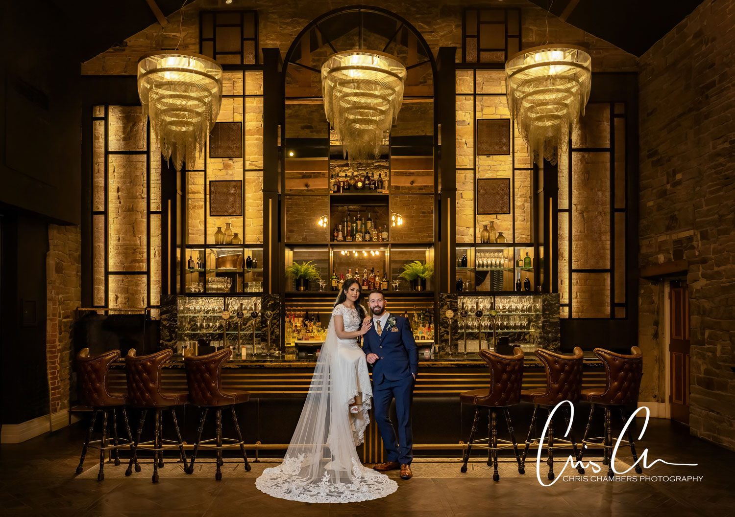 Couple posing at elegant bar at the Manor House Lindley.