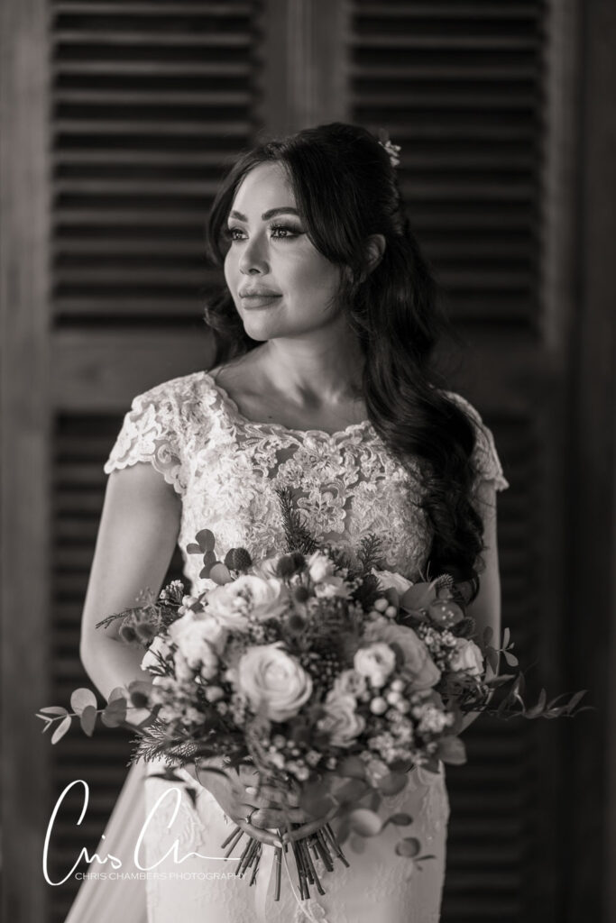 Bride holding bouquet in black and white portrait