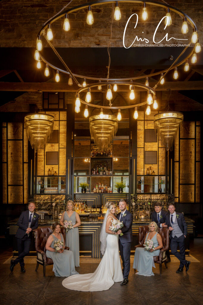 Wedding bridal party posing in the Coach House Bar at Manor House Lindley.