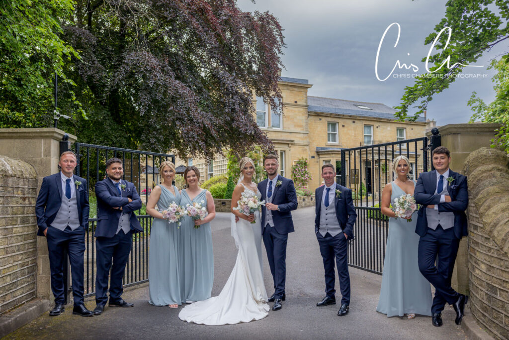 Bridal party posing outside Manor House Lindley.
