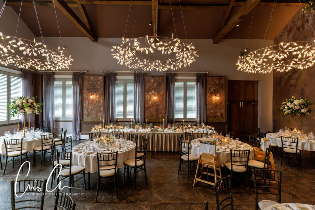 Elegant banquet hall with ornate lighting and table settings.