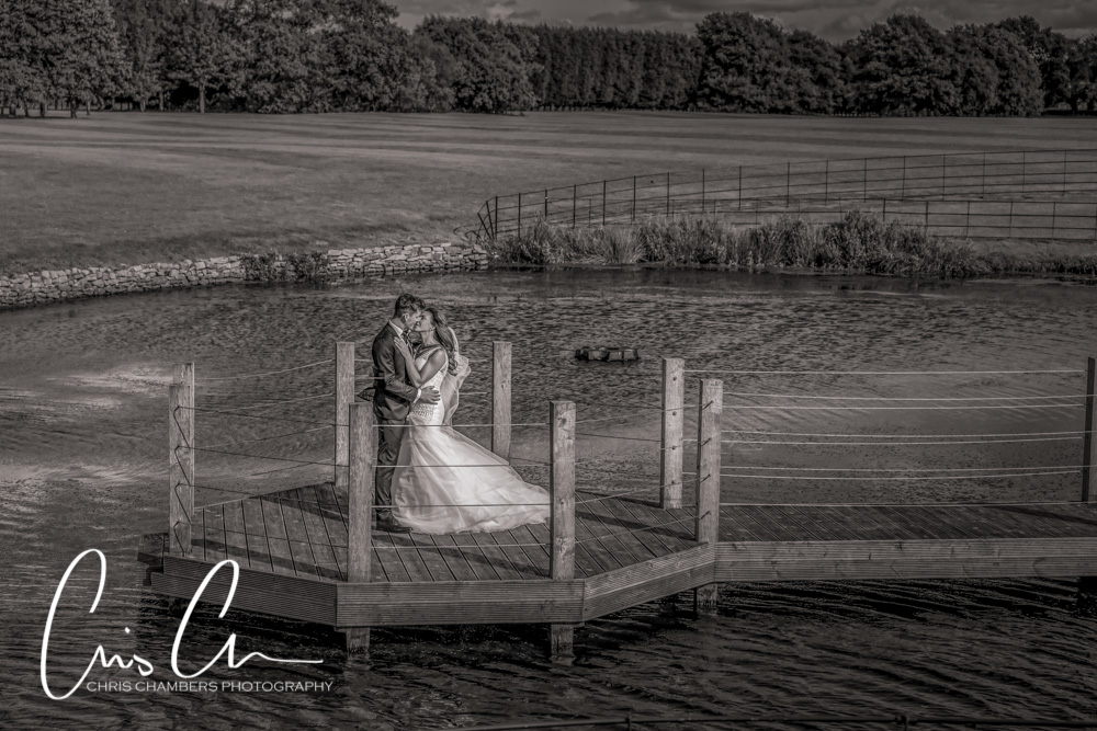 Merrydale Manor wedding photograph of a bride and groom on the jetty in black and white