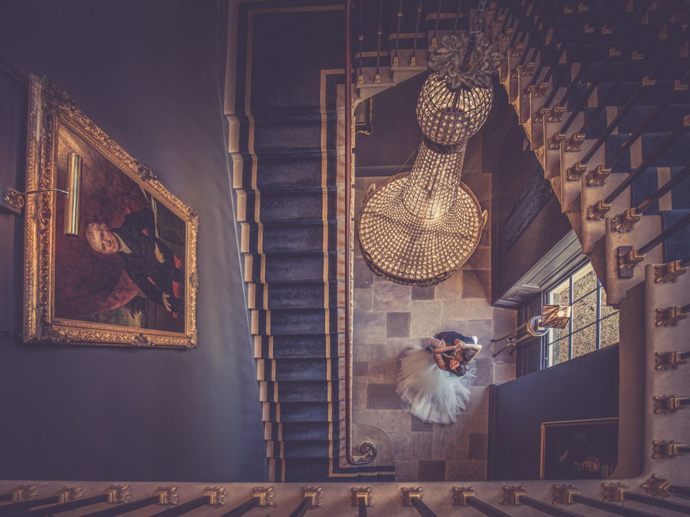 Stubton Hall staircase, bride and groom under the chandelier