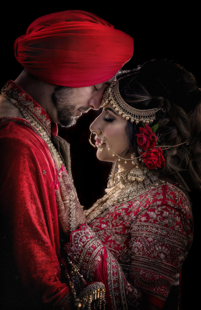 Couple in traditional Indian wedding attire, intimate pose. Yorkshire wedding photographer Chris Chambers