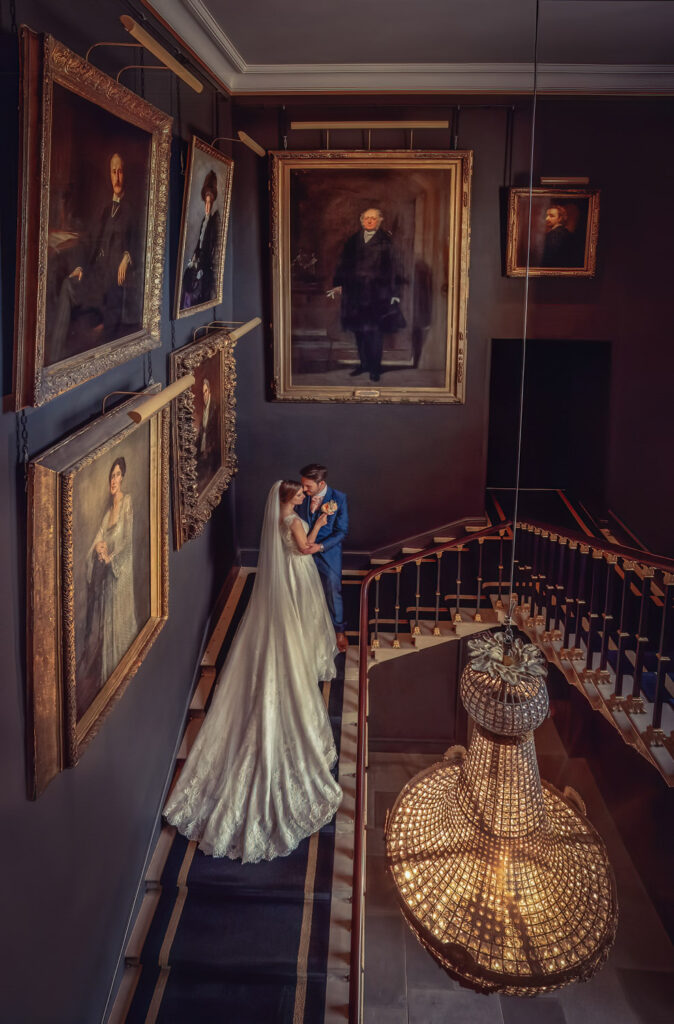 Bride and groom on the staircase at Stubton Hall