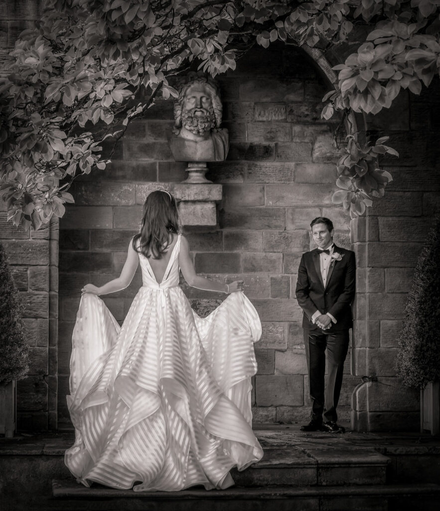 Bride approaching groom in elegant black and white setting at Rudding Park Harrogate