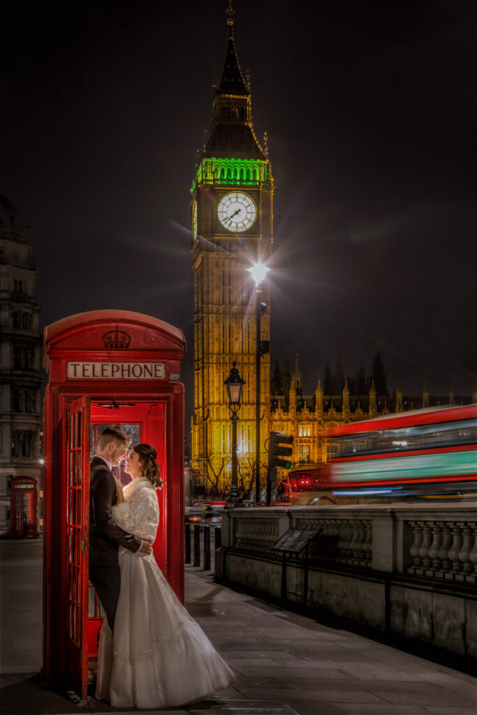 Couple kissing by red phone booth, Big Ben backdrop in central London