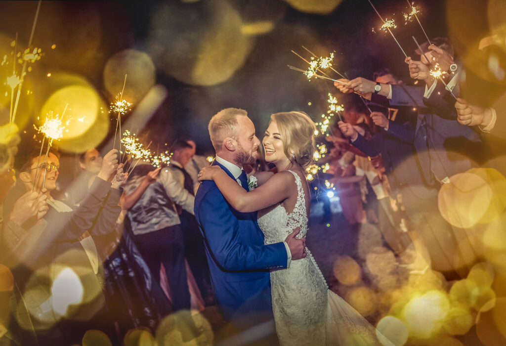 Couple embracing at sparkler-lit wedding celebration at Woodlands Hotel in Leeds