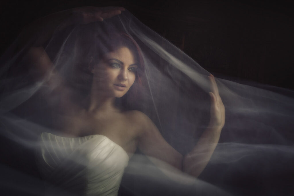 Bride draped in ethereal veil, artistic portrait. Chris Chambers Yorkshire wedding photographer