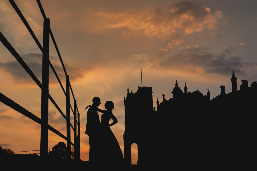 Silhouetted couple against sunset skyline, Allerton Castle