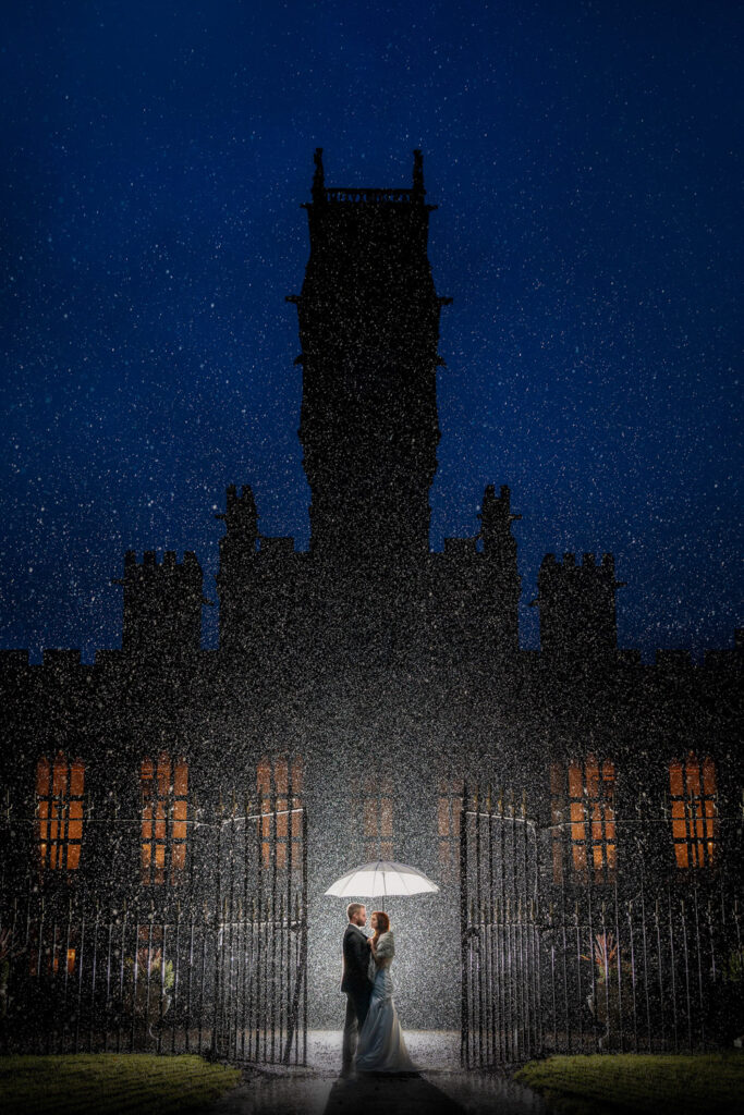 A wet wedding photograph of a bride and groom at Carlton Towers East Yorkshire