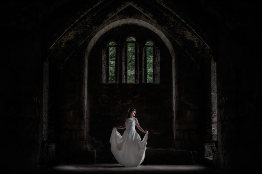 Bride in white gown inside stone chapel in leeds, Chris Chambers Yorkshire wedding photographer