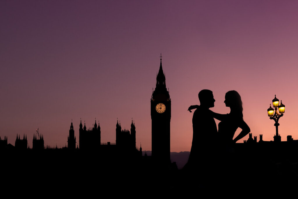 Silhouette of bride and groom against Big Ben at sunset