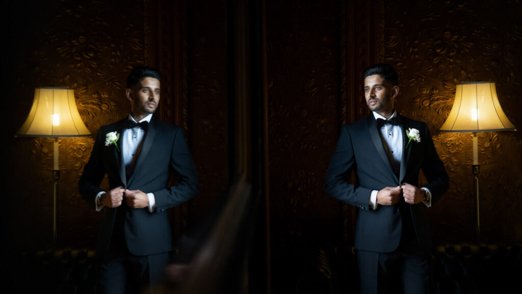 groom in black tie reflected in mirror. Luxury wedding photography