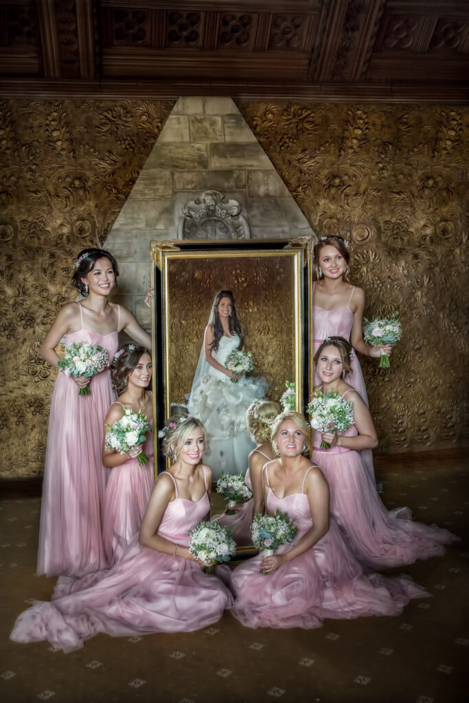 Bride and bridesmaids with flowers in elegant setting.