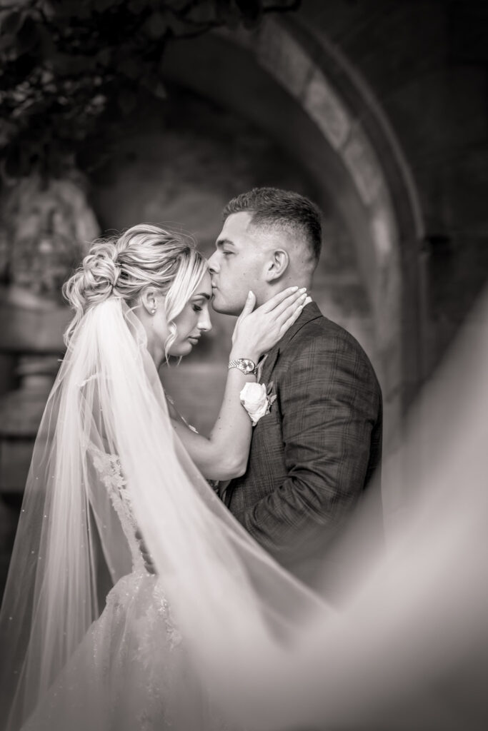 Intimate wedding couple embracing in black and white. Rudding Park Harrogate