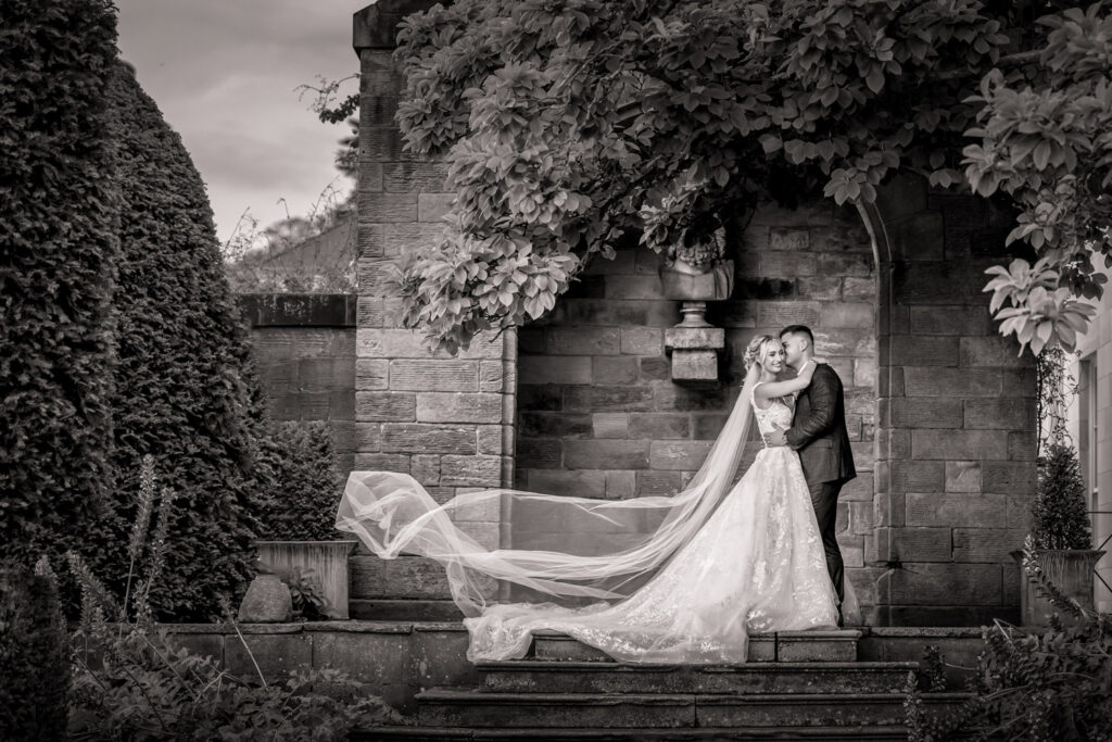 Bride and groom embracing in black and white photo at Rudding Park
