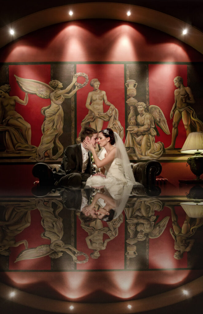 Wedding couple kissing with classical painting backdrop. Swinton Park