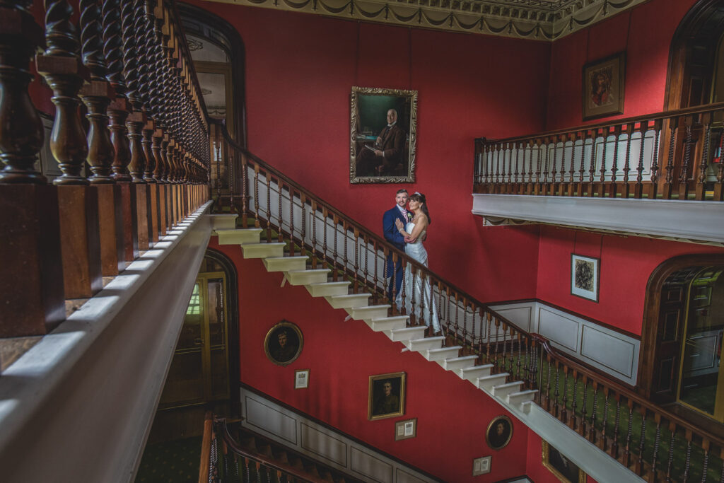 bride and groom on the main staircase at Swinton Park
