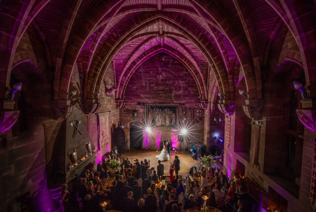 Elevated view of evening wedding reception and first dance at Peckforton Castle
