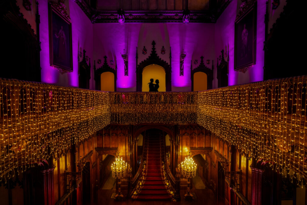 Illuminated grand hall with silhouettes and fairy lights