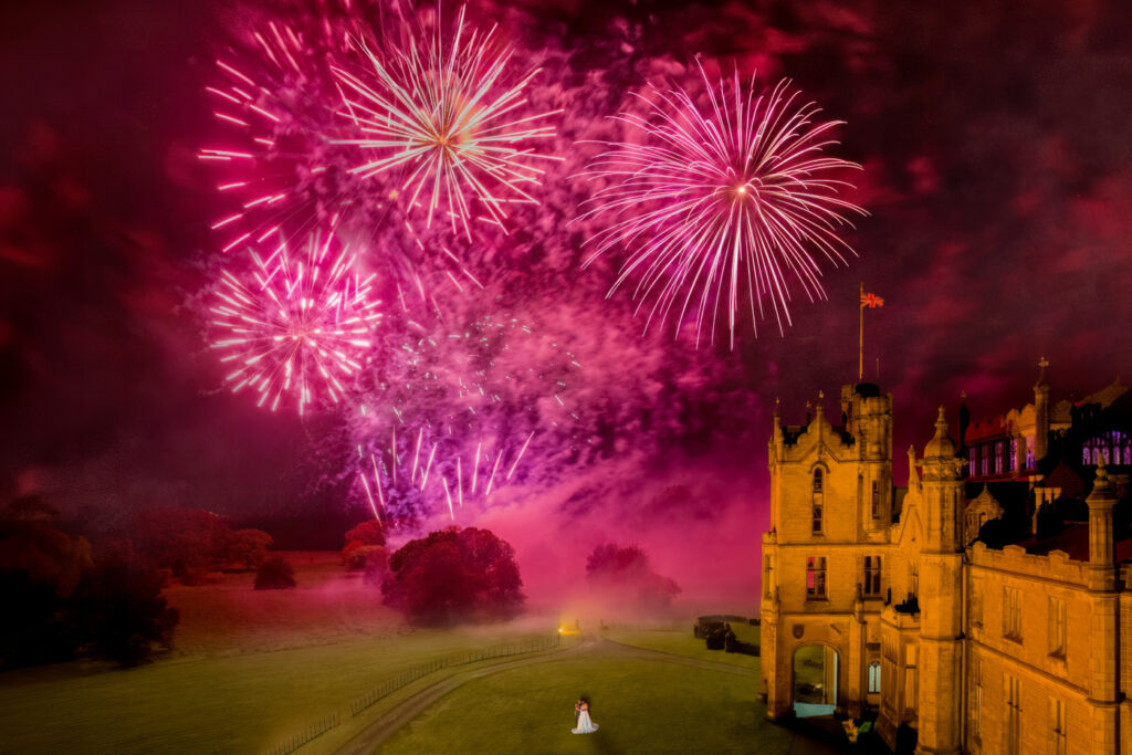Fireworks display over Allerton Castle with bride and groom