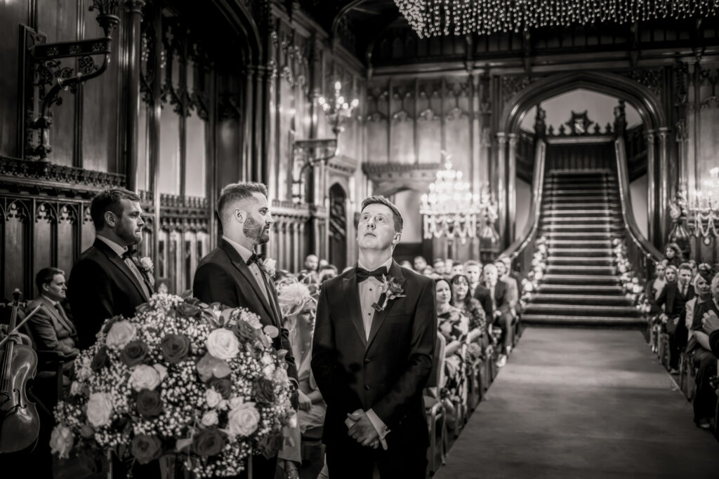 Wedding ceremony in the Great Hall at Allerton Castle, the groom waits nervously at the front