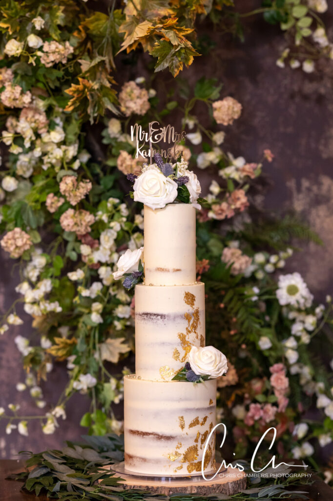 Elegant wedding cake with gold leaf detail and flowers