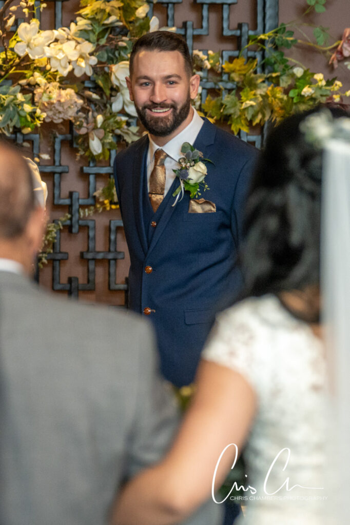 Groom smiling at bride during wedding ceremony.Manor House Lindley weddings.