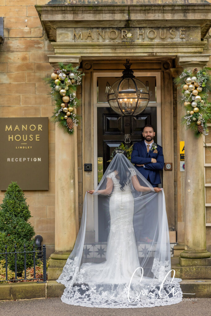 Manor House Lindley weddings. Bride and groom outside Manor House entrance.