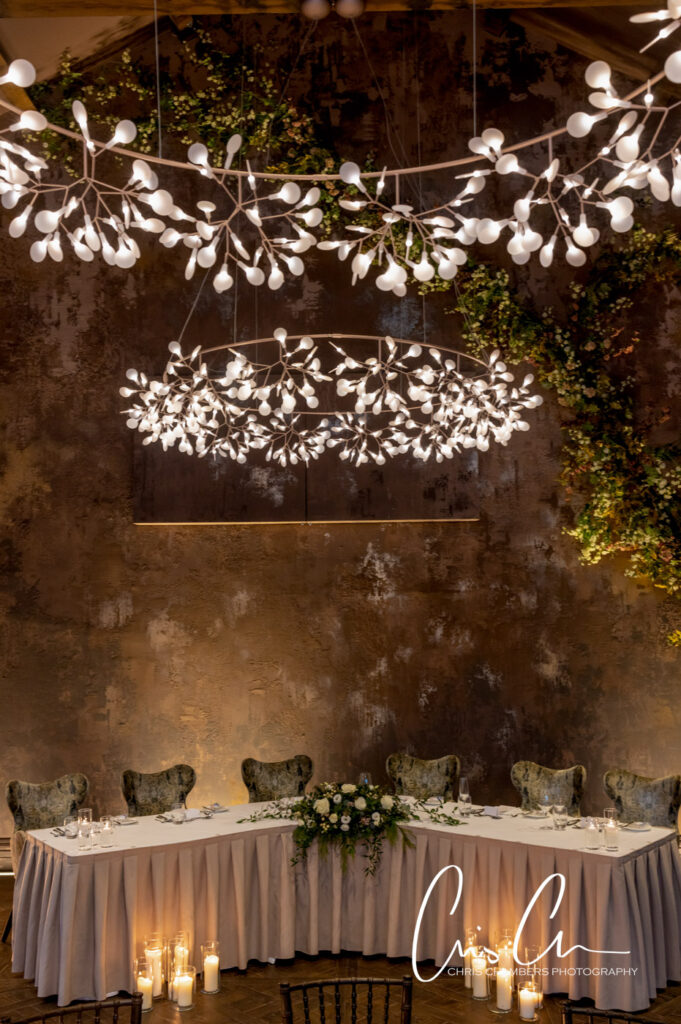 Elegant wedding reception decor with floral lights overhead Manor House Lindley weddings.