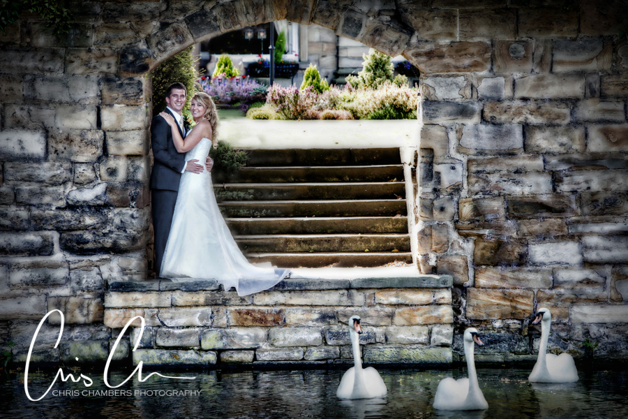 Walton Hall Archway and a bride and groom with three swans in the water.