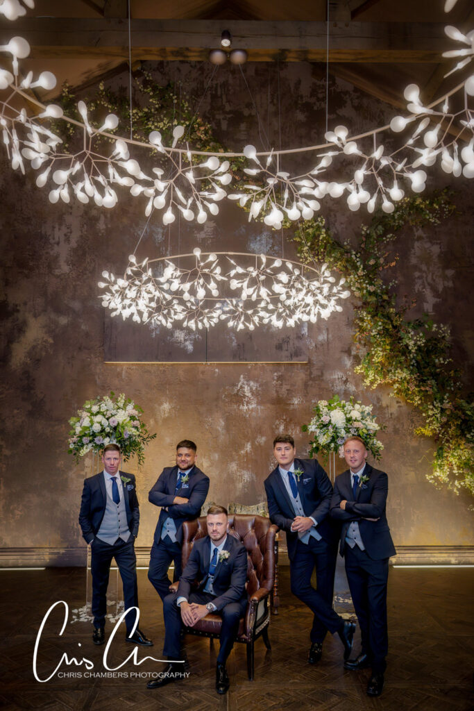 Manor House Lindley weddings, Groomsmen posing under artistic lighting installation