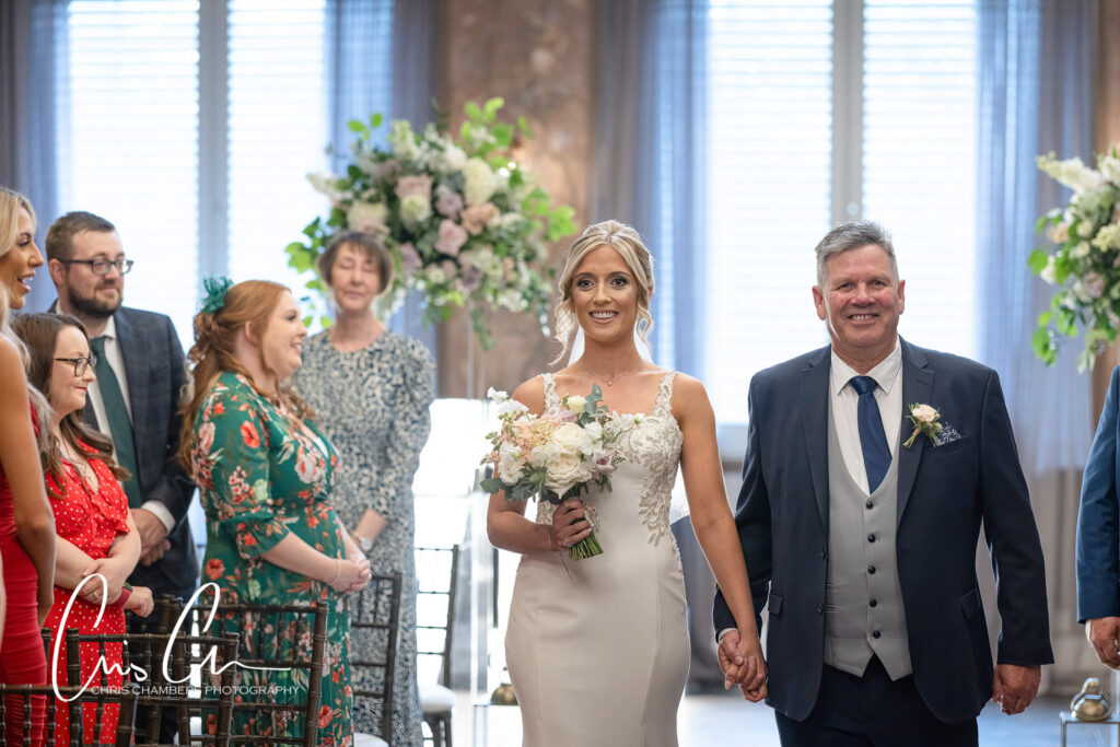 Bride walking down aisle with father at wedding ceremony. Manor House Lindley weddings