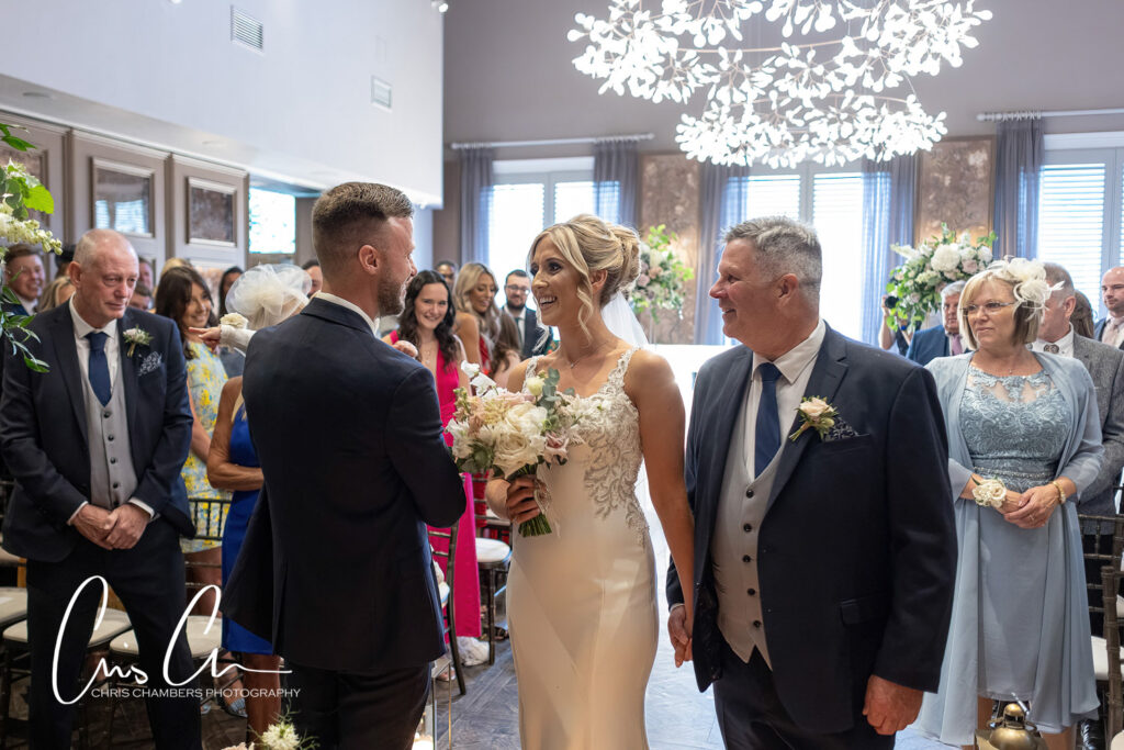 Bride walking down the aisle with father. Manor House Lindley weddings