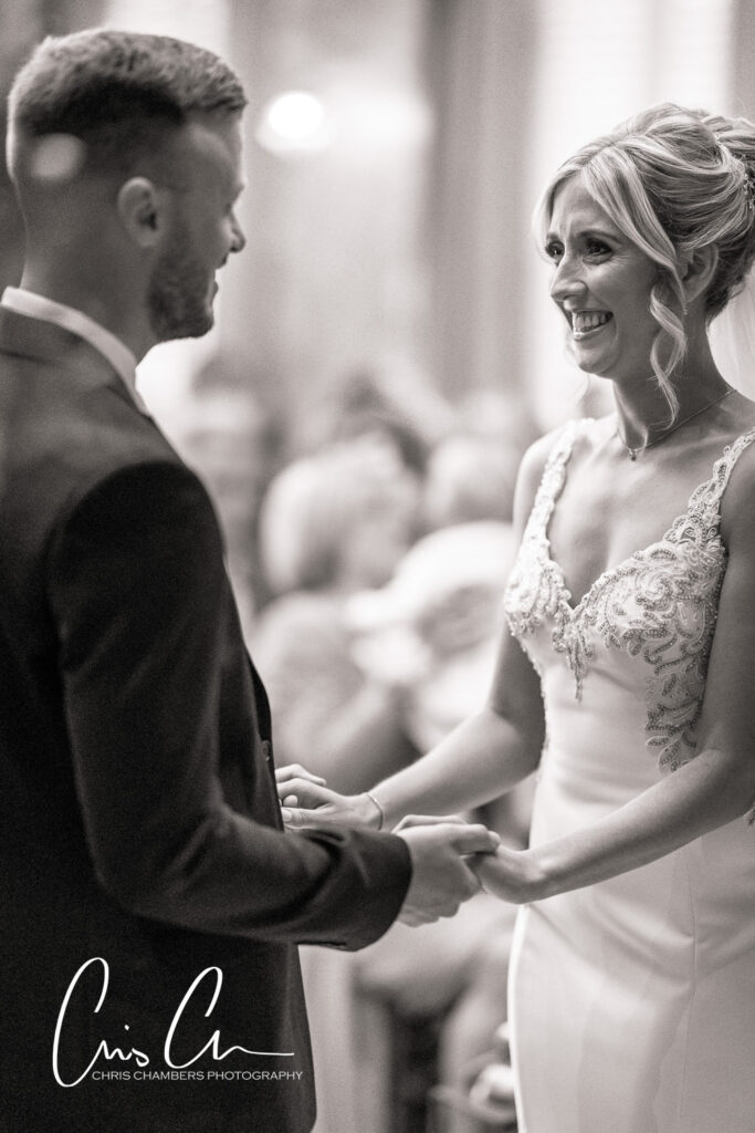 Bride and groom holding hands, wedding ceremony, black and white. Manor House Lindley weddings