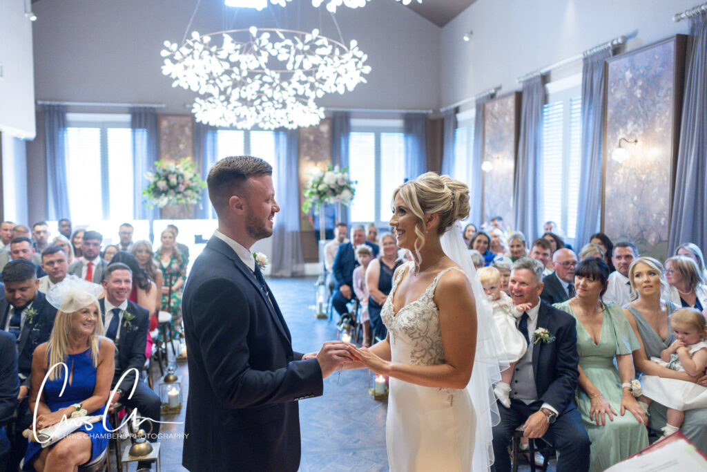 Bride and groom exchanging vows at wedding ceremony. Manor House Lindley weddings