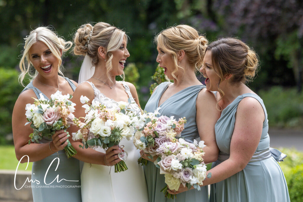 Bridesmaids laughing, holding bouquets, outdoor wedding. Manor House Lindley Wedding Photographs