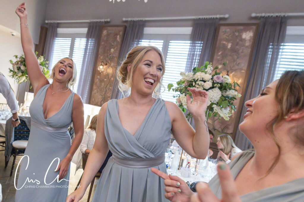 Bridesmaids laughing at wedding reception. Manor House Lindley Wedding Photographs