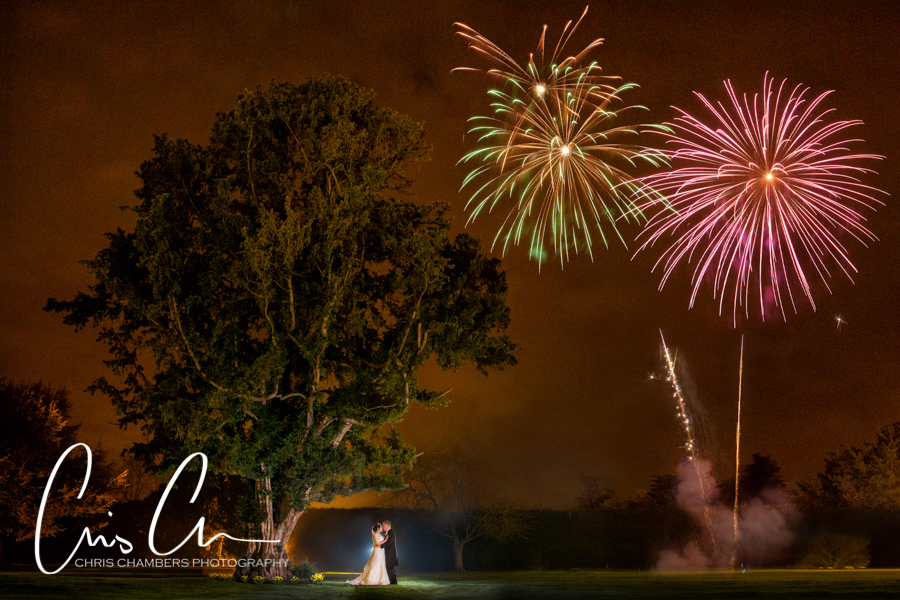 Wedding couple with fireworks at night. Hazlewood Castle Wedding Photography