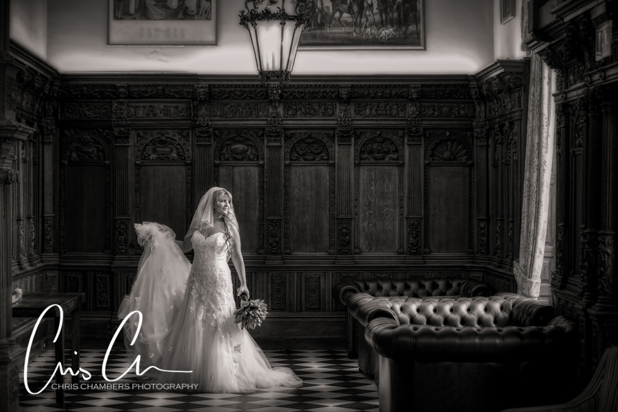 Hazlewood Castle Wedding Photography. Bride in elegant dress in vintage room.