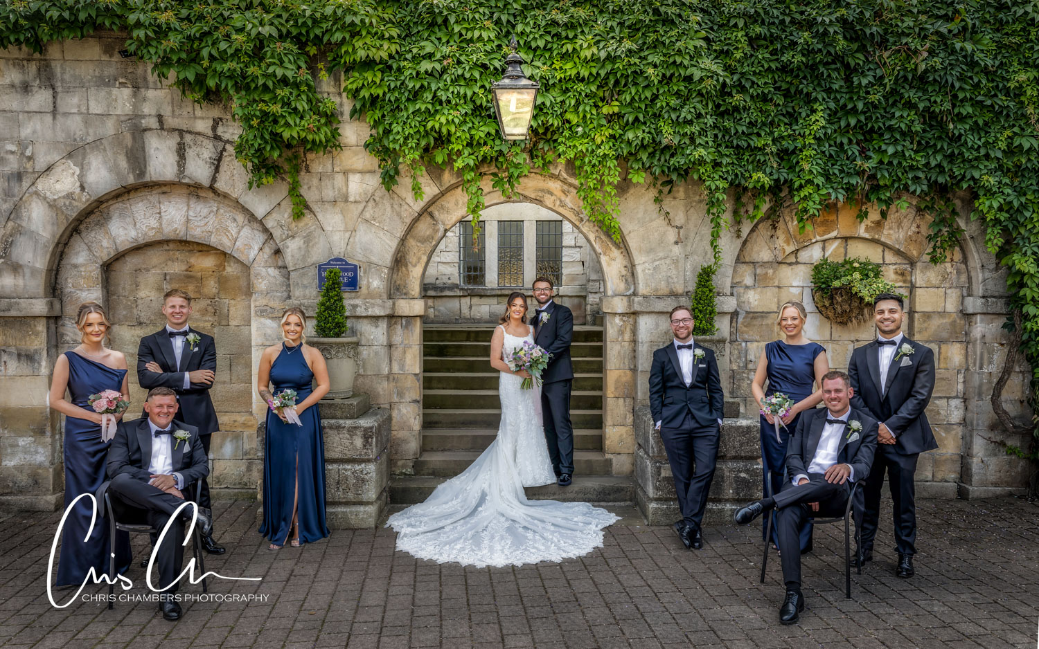 bridesmaids and groomsmen in a wedding group photo in the courtyard at Hazlewood castle