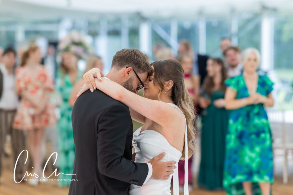 First dance of the bride and groom at Hazlewood Castle. The marquee provides a bright open space for evening wedding receptions