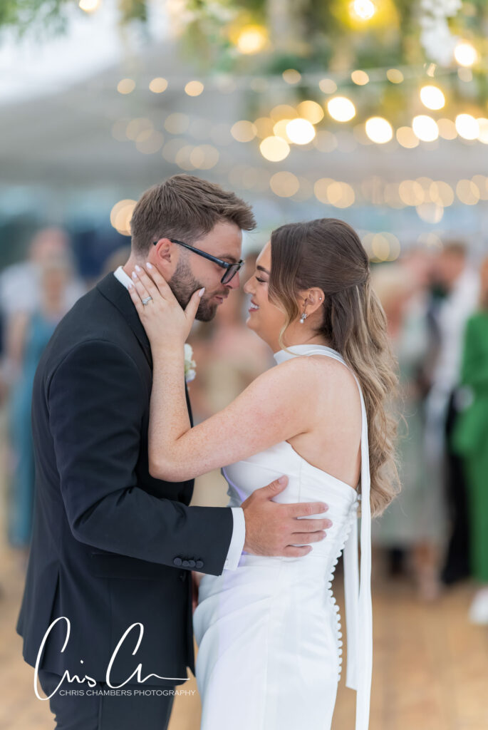 First dance of the bride and groom at Hazlewood Castle. The marquee provides a bright open space for evening wedding receptions